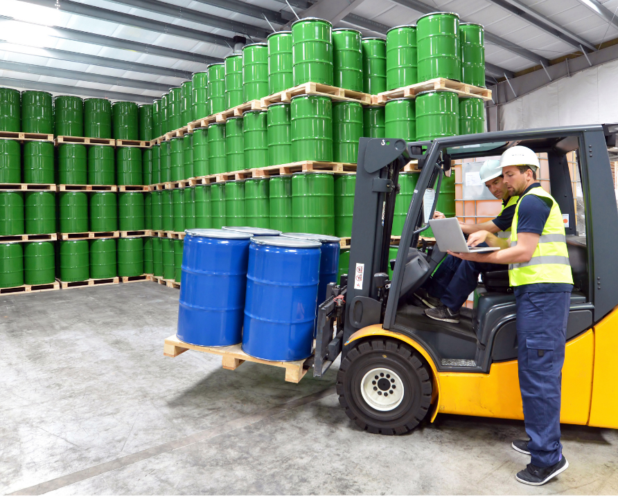 A safety Manager reviewing SDS for chemical handling and storage and a forklift operator completing an audit through Safety Champion on a laptop