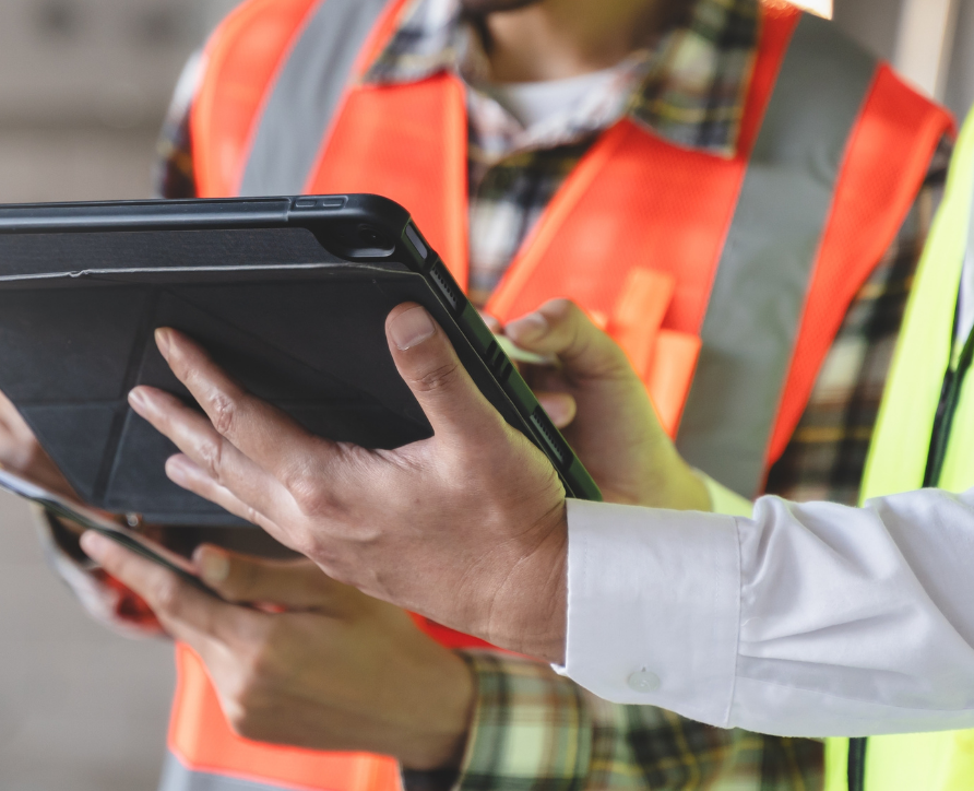Safety Manager onboarding contractor via Safety Champion App on a tablet.