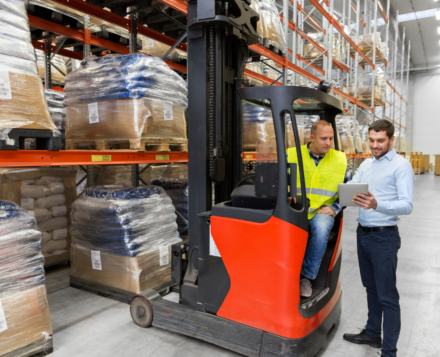 A forklift operator and a safety manager completing a daily pre start check.