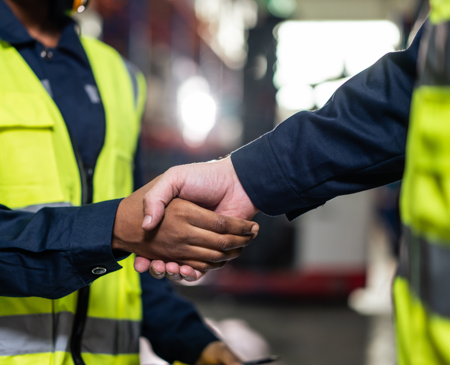 HR Profesional shaking hands with a new worker during onboarding