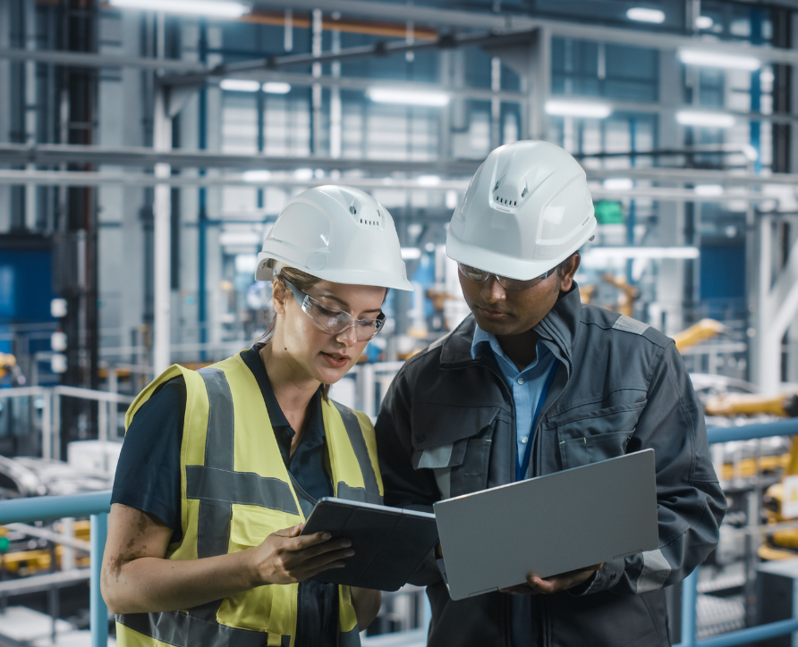 A safety officer and engineer reviewing licences at a plant site.