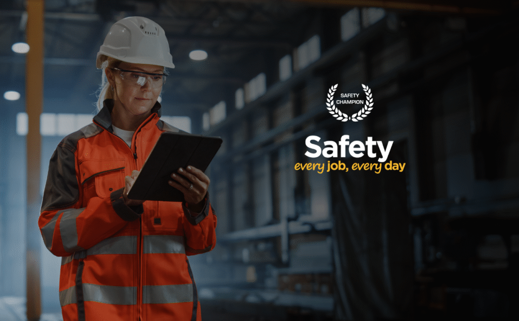 A safety manager wearing PPE and smiling during national safety month at safety champion software