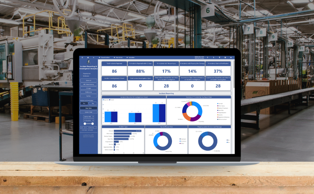 A laptop showing safety metrics improving via OHS Software at a manufacturing company